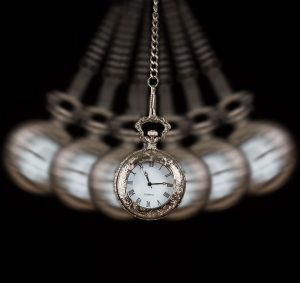 21710015 - pocket watch silver swinging on a chain black background to hypnotise