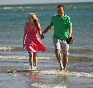 happy couple walking along the beach